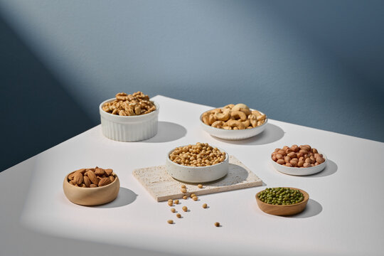 Assorted Nuts and Beans in Bowls on White Table