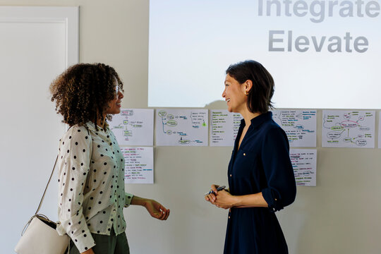 Two businesswomen having a conversation at modern office