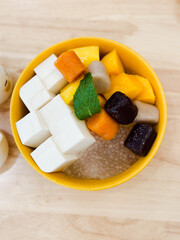 Cold dessert made up of tofu base with taro,mango and sago
