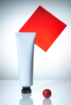 White tube, red square, and small sphere on light gray background