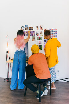 Team brainstorming and photo selection in creative workspace