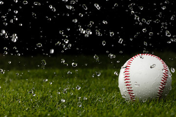Baseball ball sits on a wet rain grass field. Express joy peaceful moment during rain shower as droplet over grass field to show happy smile baseball ball