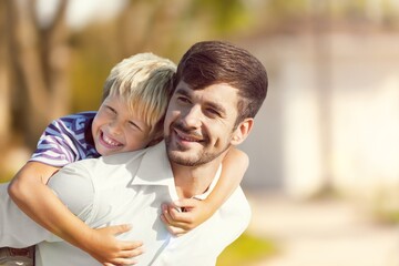 Fototapeta premium Happy young father with son having fun