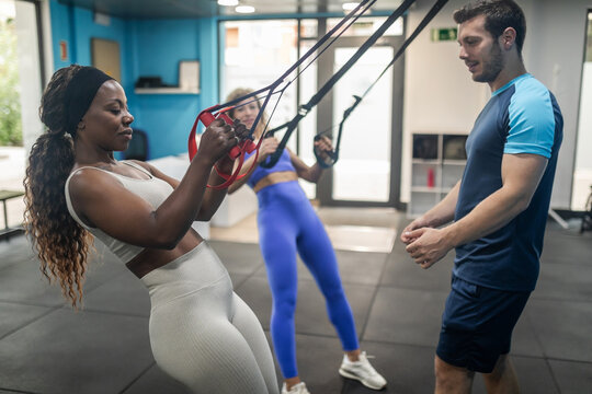 Small multiracial group doing sports in a gym.