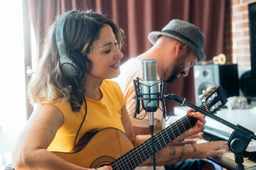 Artists composing a song in a recording studio