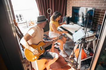 Musicians enjoying time together playing music at studio home