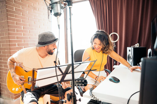 Musicians enjoying time together playing music at studio home