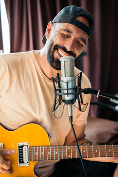 Artist singing and playing guitar