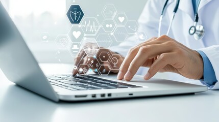 The hand of a doctor in a white coat navigating a laptop