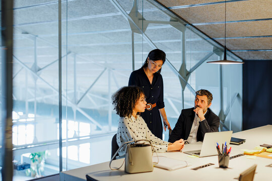 Business people having meeting around office desk