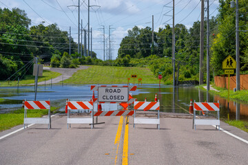 Florida tropical storm. Hurricane flood  road blocked off. School road damaged. Danger for car and...