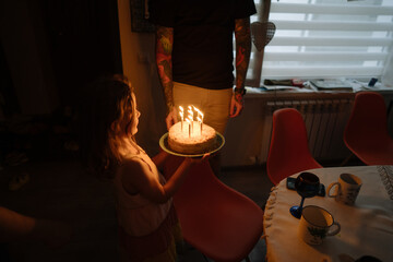 Family celebrating birthday at home