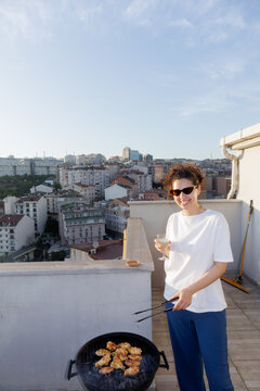 young woman grilling barbecue