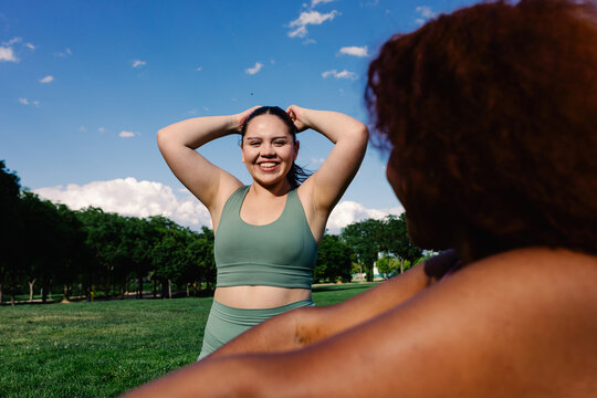 Diverse curvy friends have good time during outdoor exercise session
