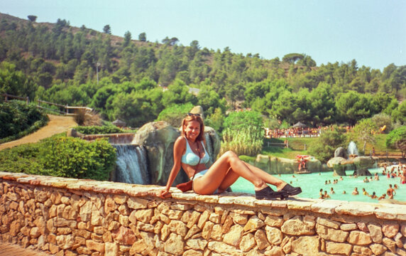 portrait with anological film of teenager in the pool having fun