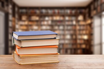 stack of reading books on desk in library