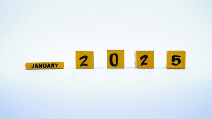 Wooden block calendar for January 2025. Yellow on a white background