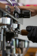 To prepare an espresso, finely ground coffee is used to brew a small, concentrated shot of coffee. The process begins by tamping the coffee grounds tightly into the portafilter. Hot water, under high 