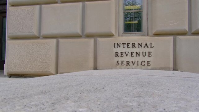 Panning video across the words "Internal Revenue Service" on the side of the IRS building in Washington, DC