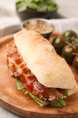 Tasty sandwich with bacon on grey table, closeup