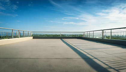 晴れた校舎の屋上。コンクリート、手すり、青空のある屋上の風景。A sunny day on the roof of a school building. A rooftop view with concrete, railings and blue sky.