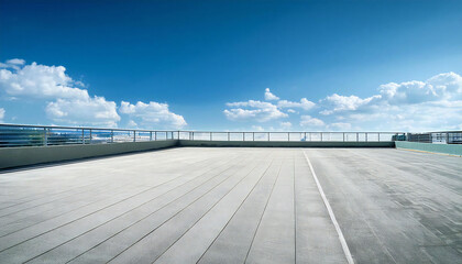 晴れた校舎の屋上。コンクリート、手すり、青空のある屋上の風景。A sunny day on the roof of a school building. A rooftop view with concrete, railings and blue sky.