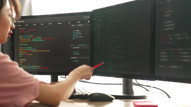 Back end software developer engineer for computer programming working together on debugging writing computing code, solving complex algorithms display on monitor in office. Burgeoning