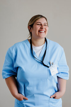 Female doctor smiling with hands in pockets
