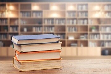 stack of reading books on desk in library