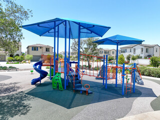 Colorful children playground activities in community public park Children run, slide, swing on modern playground. 