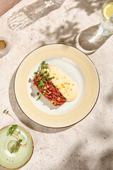 Gourmet Beef Tartare with Parmesan Mousse in Sunlit Still Life Setting