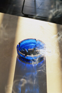 Ashtray with burning cigarette