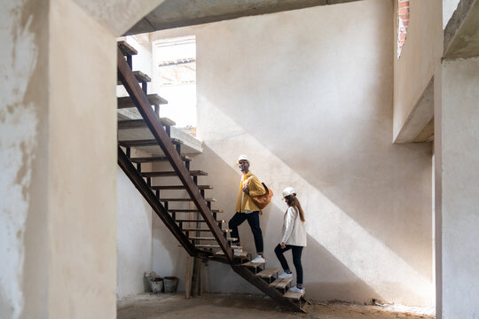 Happy Couple In Their New House Under Construction