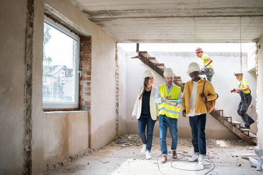 Architect Showing Construction Plans To Investors