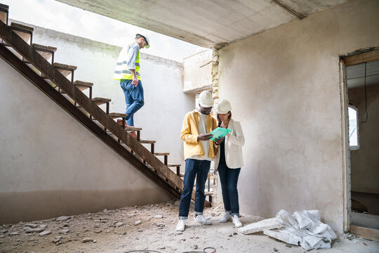 Architects Discussing Building Plans During Renovation