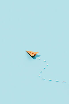 Single Orange Paper Plane with Dashed Path on Blue Background