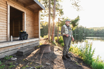 Fisherman Relaxing by Forest Cabin
