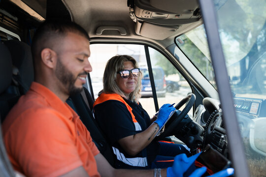 Two paramedics preparing for an intervention inside ambulance