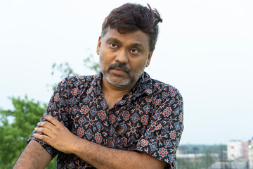 Portrait of a middle aged man wearing printed shirts at outdoors
