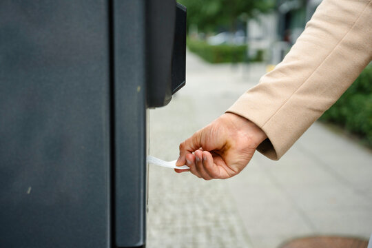 A man pays for parking at a vending machine