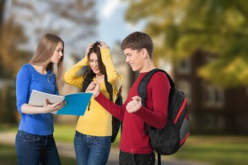 Happy young college friends at campus.