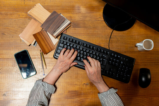 Senior woman's hand on computer keyboard 