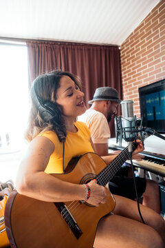 Artists composing a song in a recording studio