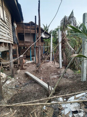 a vertical photo of an abandoned house in Thailand