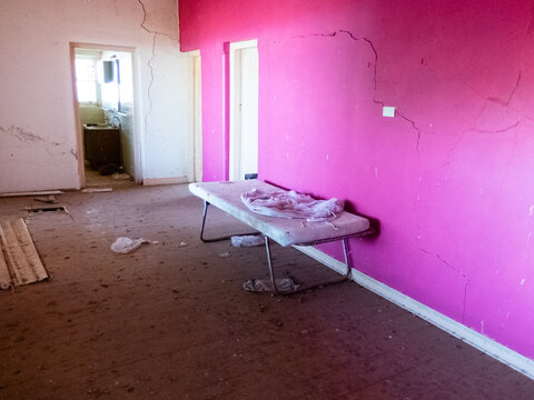 Mattress against a pink wall, in an abandoned home, outback Australia.