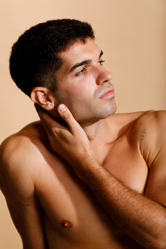 Shirtless Man Over Beige Background