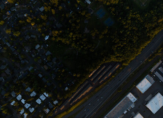 Shooting from the air. Large highway near the city. Night. Lots of greenery. Residential buildings, industrial buildings. The beauty of nature, map, topography, ecology.