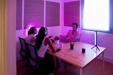 Group podcast recording session with illuminated purple lighting
