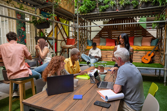 Collaborative outdoor workplace with multi-ethnic colleagues