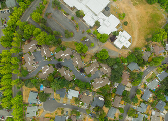 Fototapeta premium Aerial view of car parking, green bushes. Construction, infrastructure, road transport, landscaping of infrastructure facilities.